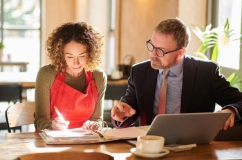 Man and woman looking over papers